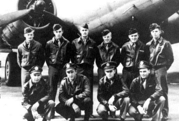 Phil Olander with members of the United States Army Air Corps in front of plane
